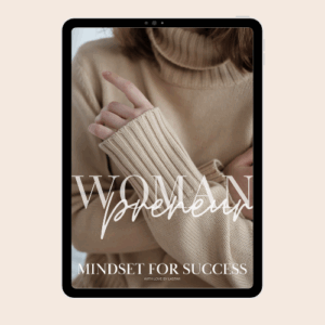 Woman in tan sweater with letter womenprenuer